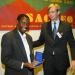 Mr. Herald Voorneveld (Netherlands) presenting a SACMEQ research medal to Mr. Saul Murimba (Zimbabwe).