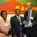 Mr. Herald Voorneveld (Netherlands) presenting SACMEQ Research Medal to Ms. Florence Thuku (Kenya) and Dr. Njora Hungi (Kenya).